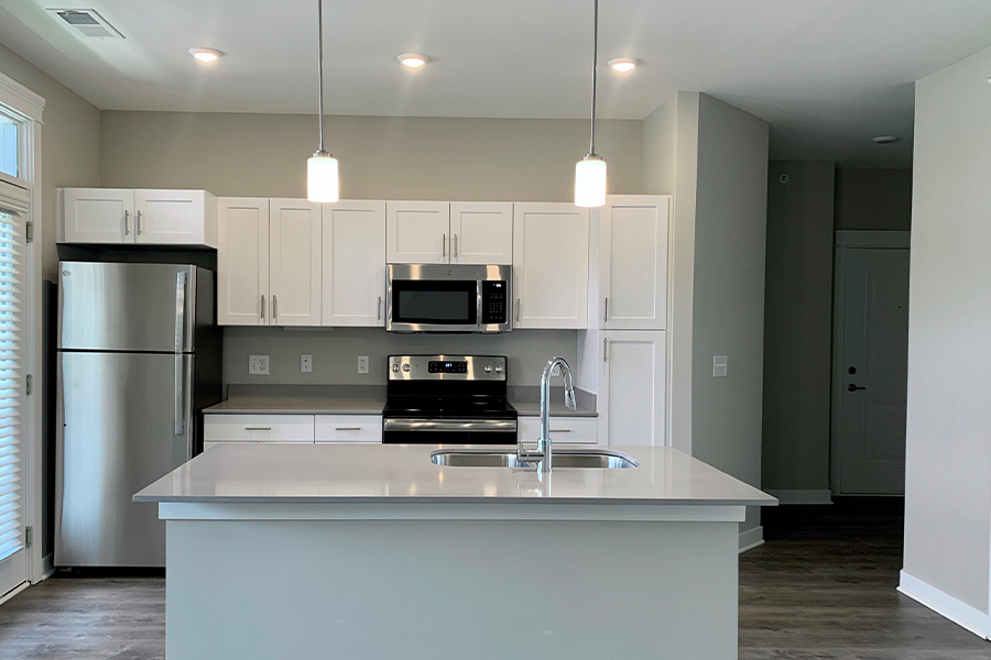 Apartment kitchen with stainless steel appliances and large island