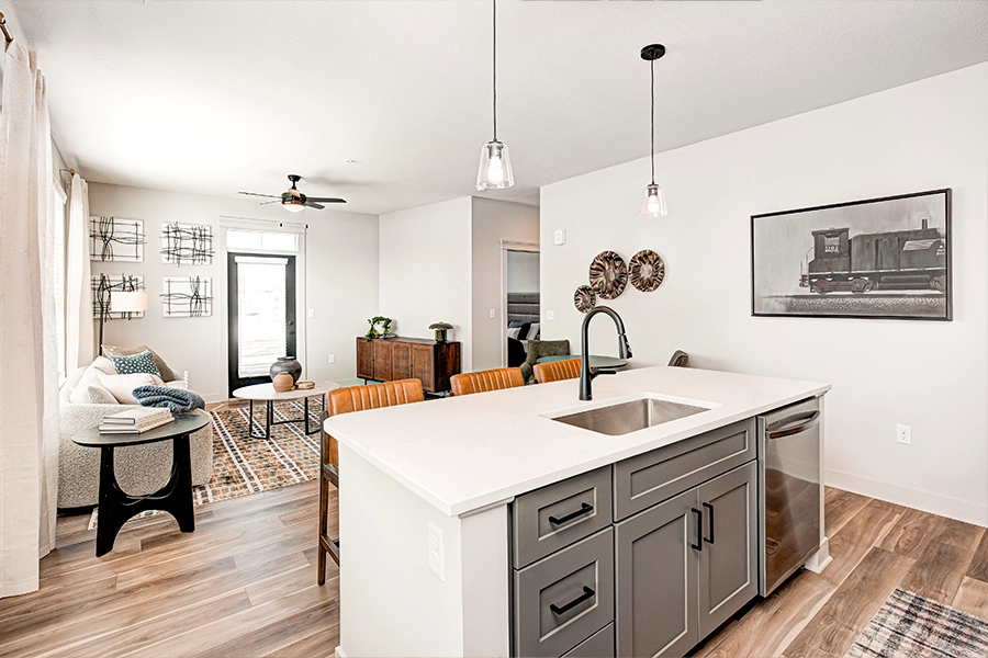 Coach house apartments like at Crossing 5 are known for spacious layouts. A modern apartment kitchen island and living room