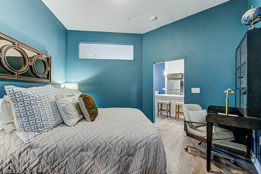 Guest bedroom with matching nightstands, table lamp, and mirror.