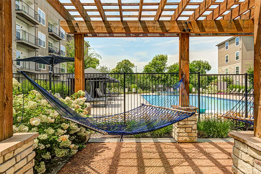 If you don't need the community business center, skip it and tour amenities that interest you more, like this pristine pool area at The Verge Apartments. A hammock overlooking the blue pool at The Verge Apartments